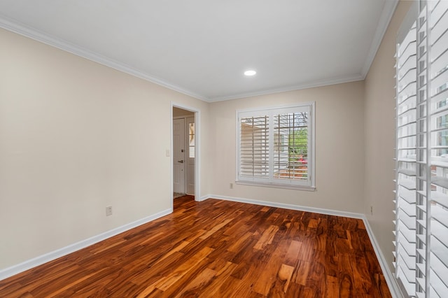 spare room featuring recessed lighting, baseboards, wood finished floors, and crown molding