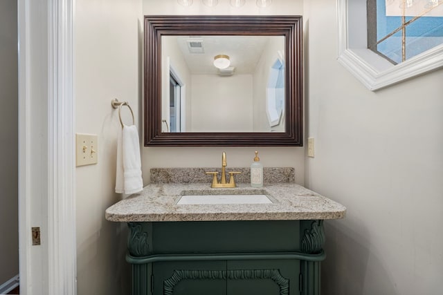 bathroom with visible vents and vanity