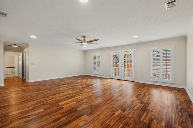 unfurnished living room with visible vents, baseboards, ornamental molding, french doors, and wood finished floors