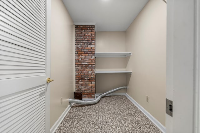 washroom featuring baseboards