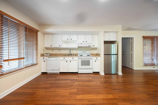2231 Holly Ln, Pine Mountain, GA 31822 - kitchen with white appliances, under cabinet range hood, dark wood finished floors, and white cabinetry