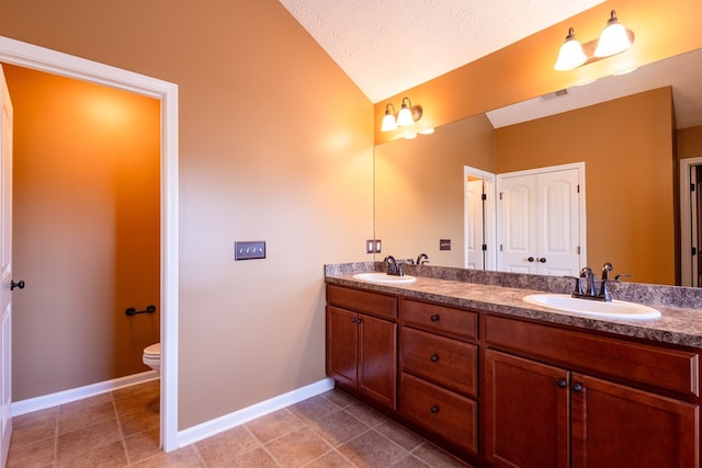 1 Cambridge Ct, Phenix City, AL 36870 - full bath featuring lofted ceiling, double vanity, toilet, baseboards, and tile patterned floors
