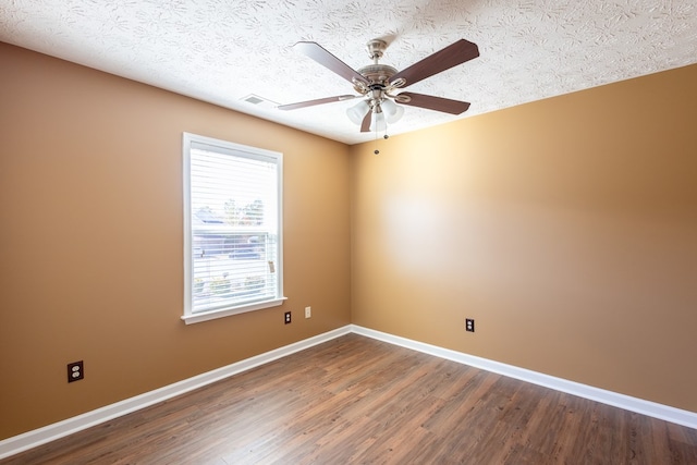1 Cambridge Ct, Phenix City, AL 36870 - spare room with dark wood-style floors, a ceiling fan, baseboards, and a textured ceiling