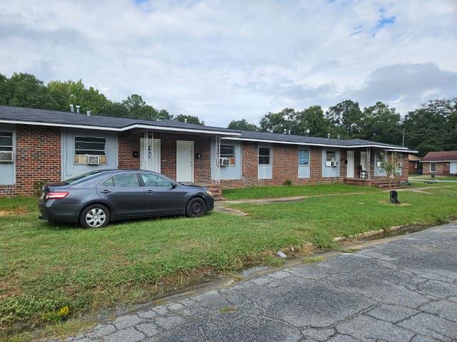 ranch-style home with a front lawn