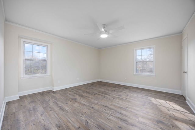 spare room with crown molding, ceiling fan, plenty of natural light, and light hardwood / wood-style floors