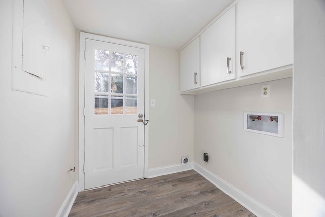 laundry room with dark hardwood / wood-style flooring, washer hookup, and cabinets