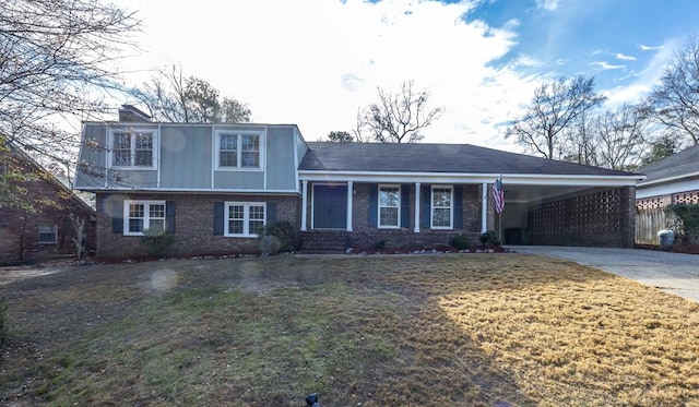 tri-level home with a carport and a front lawn