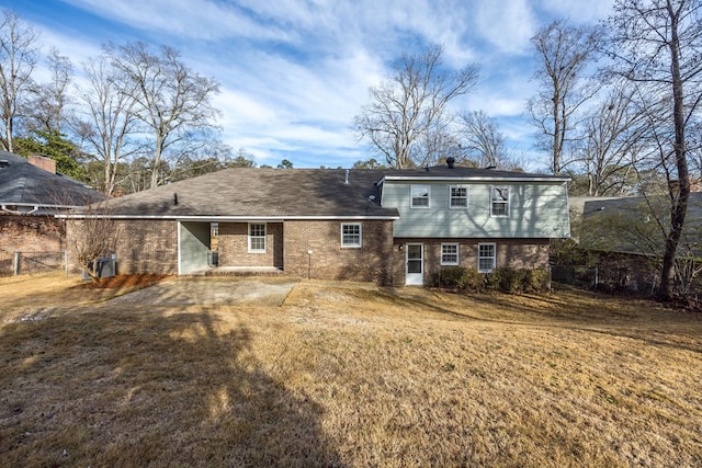 back of property featuring a yard and central air condition unit