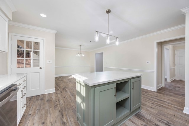 kitchen with pendant lighting, stainless steel dishwasher, a center island, and light stone countertops