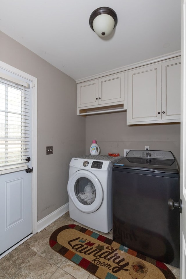 laundry area featuring cabinets and separate washer and dryer