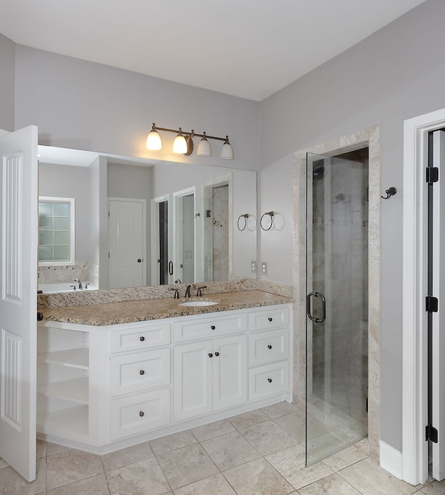 bathroom with vanity and a shower with door