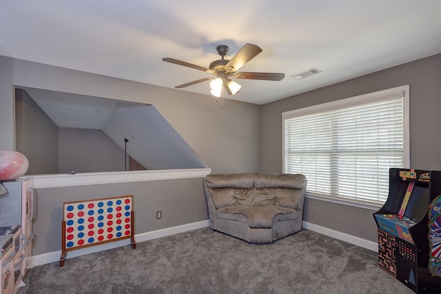 sitting room with ceiling fan and carpet flooring