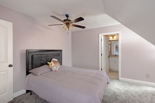 carpeted bedroom with ceiling fan and connected bathroom