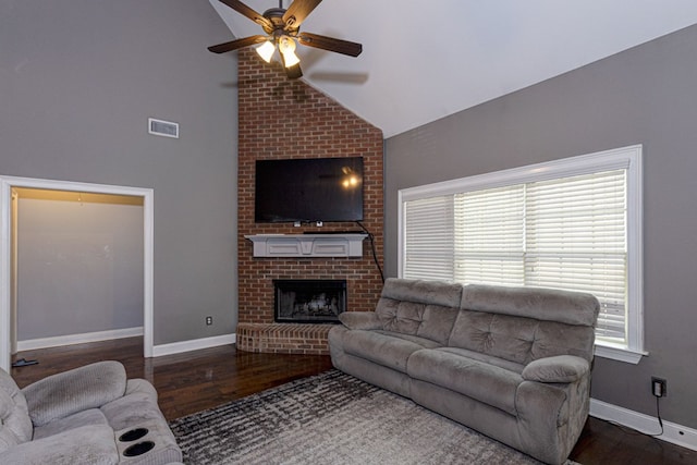 living room with hardwood / wood-style flooring, a fireplace, high vaulted ceiling, and ceiling fan