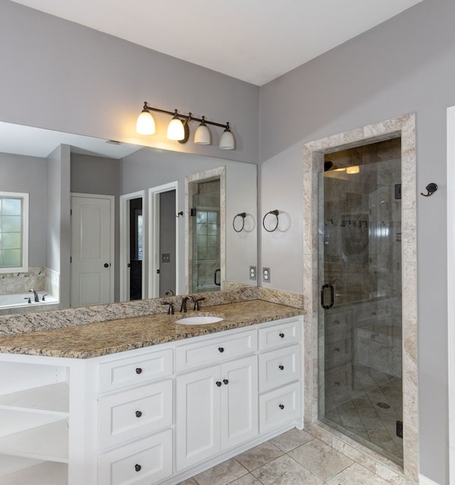 bathroom with an enclosed shower, vanity, and tile patterned flooring