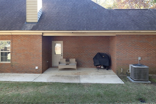 rear view of property featuring a patio and central AC