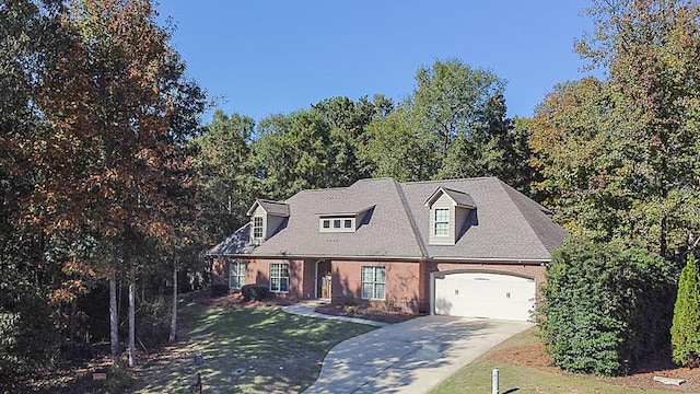 new england style home with a garage and a front lawn