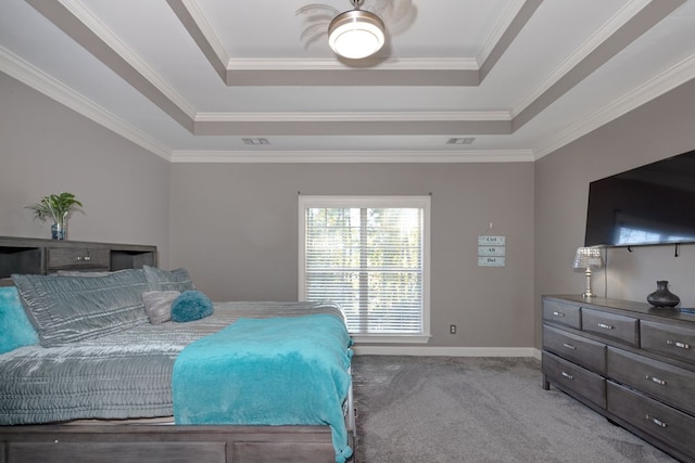 bedroom with a raised ceiling, ornamental molding, and carpet