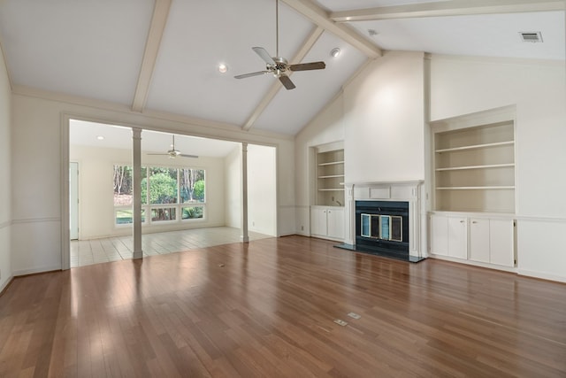 unfurnished living room featuring beam ceiling, built in shelves, ceiling fan, high vaulted ceiling, and wood-type flooring