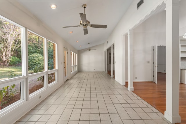 unfurnished sunroom featuring ceiling fan, decorative columns, and vaulted ceiling