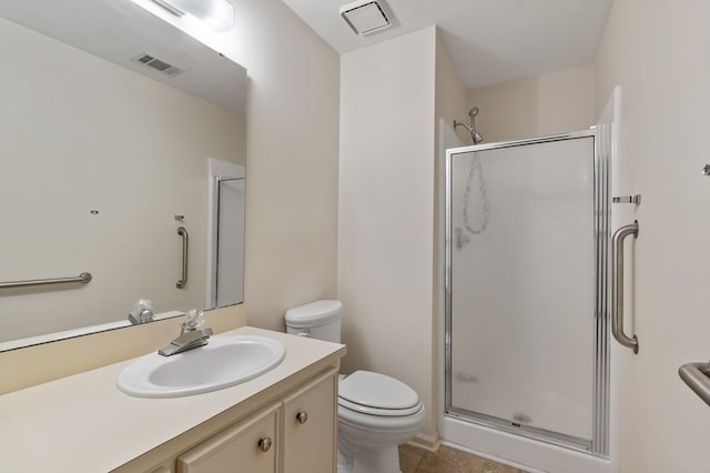 bathroom featuring tile patterned flooring, vanity, toilet, and an enclosed shower