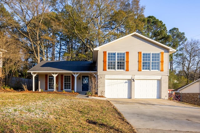 tri-level home featuring a garage and a front lawn