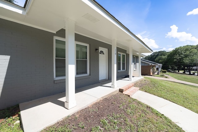 20 Benning Dell Dr, Columbus, GA 31903 - view of exterior entry with covered porch, brick siding, and a yard