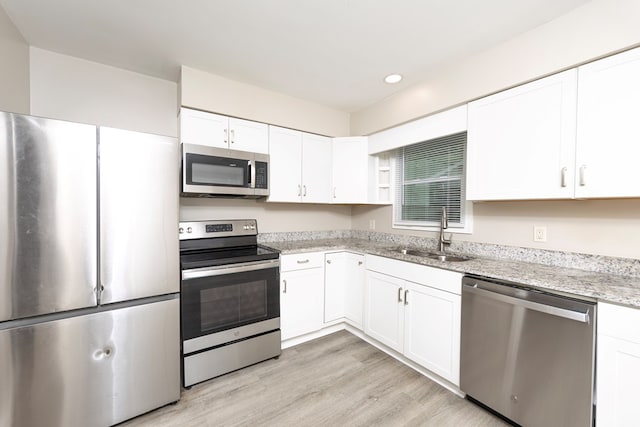 20 Benning Dell Dr, Columbus, GA 31903 - kitchen featuring stainless steel appliances, white cabinetry, light stone counters, light wood-style floors, and recessed lighting