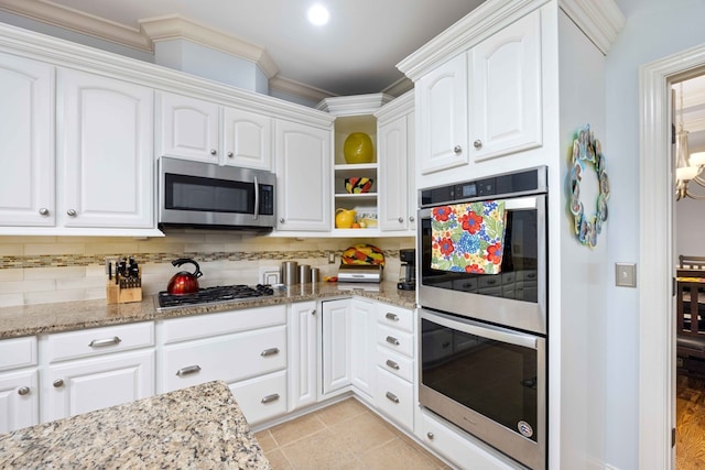 4730 Turnberry Ln Unit 15, Columbus, GA 31909 - kitchen featuring stainless steel appliances, white cabinetry, backsplash, light stone countertops, and crown molding
