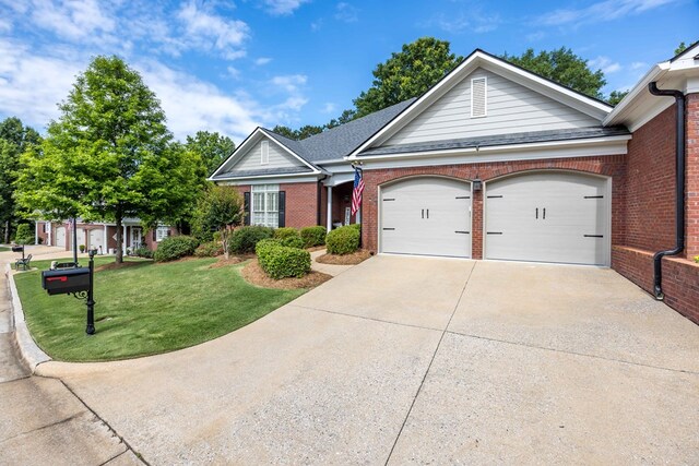 4730 Turnberry Ln Unit 15, Columbus, GA 31909 - ranch-style house with concrete driveway, an attached garage, brick siding, and a front lawn