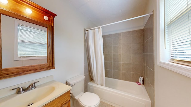 bathroom with plenty of natural light, shower / bath combo with shower curtain, toilet, and vanity