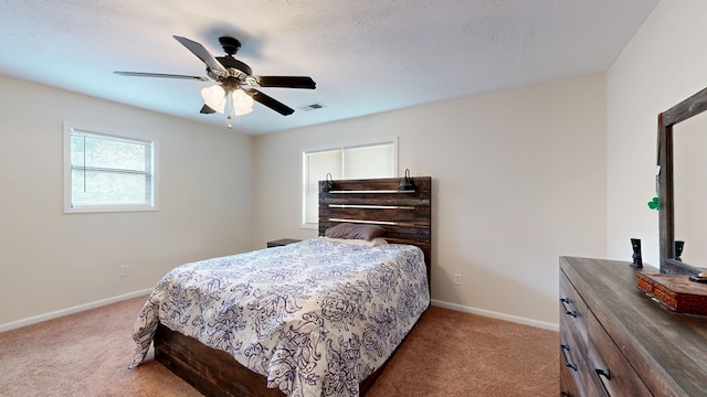 bedroom with light colored carpet, baseboards, and visible vents