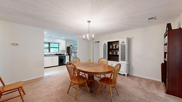 dining area with baseboards, visible vents, light colored carpet, and a chandelier