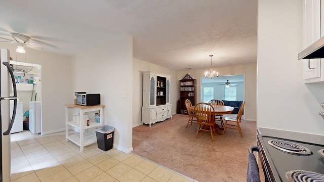 dining room with light tile patterned floors, baseboards, light carpet, and ceiling fan with notable chandelier