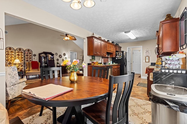 dining area with a ceiling fan and a textured ceiling