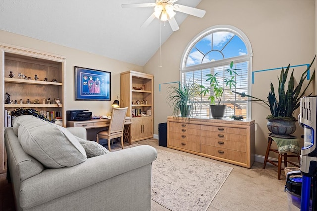 office area with baseboards, a ceiling fan, light colored carpet, high vaulted ceiling, and built in desk