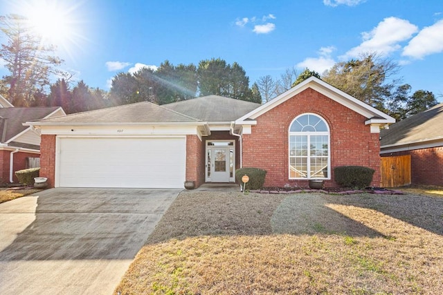 single story home with an attached garage, driveway, a front lawn, and brick siding