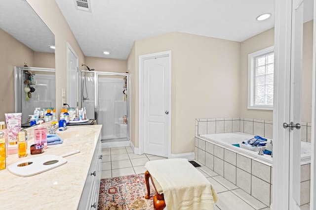 bathroom with vanity, visible vents, a shower stall, a bath, and tile patterned floors