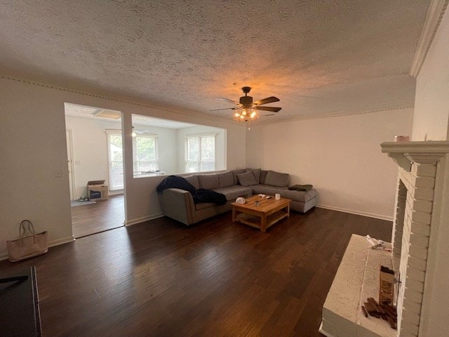 unfurnished living room featuring baseboards, a fireplace, a textured ceiling, a ceiling fan, and dark wood-style flooring