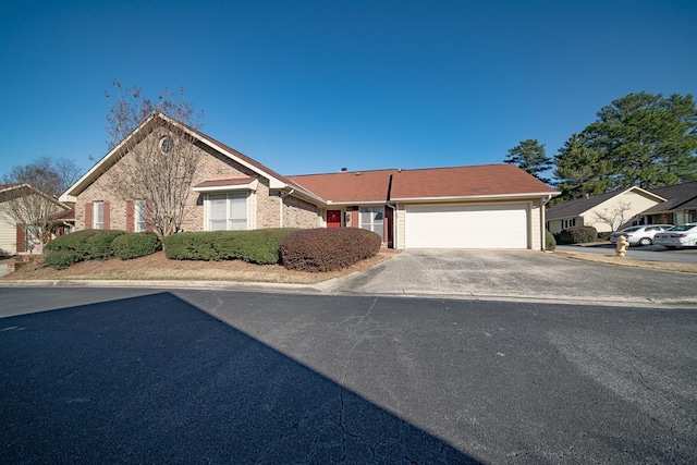 ranch-style home with a garage and concrete driveway