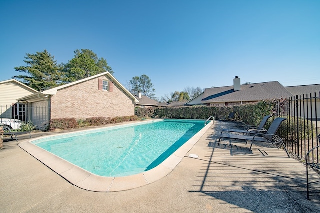 view of pool with a patio area, fence, and a fenced in pool