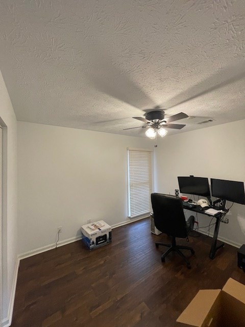 office space with ceiling fan, a textured ceiling, baseboards, and wood finished floors