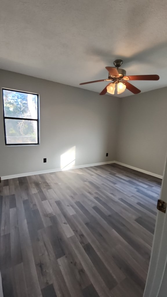 166 Pine Ridge Dr, Union Springs, AL 36089 - empty room featuring a ceiling fan, dark wood finished floors, and baseboards