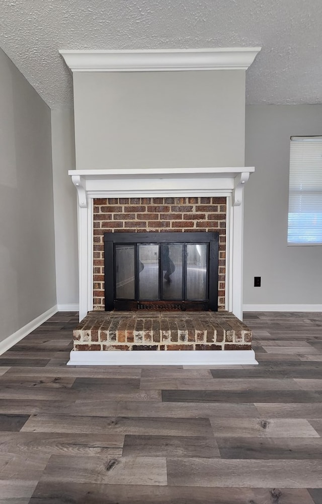 166 Pine Ridge Dr, Union Springs, AL 36089 - detailed view of a fireplace, a textured ceiling, wood finished floors, and baseboards