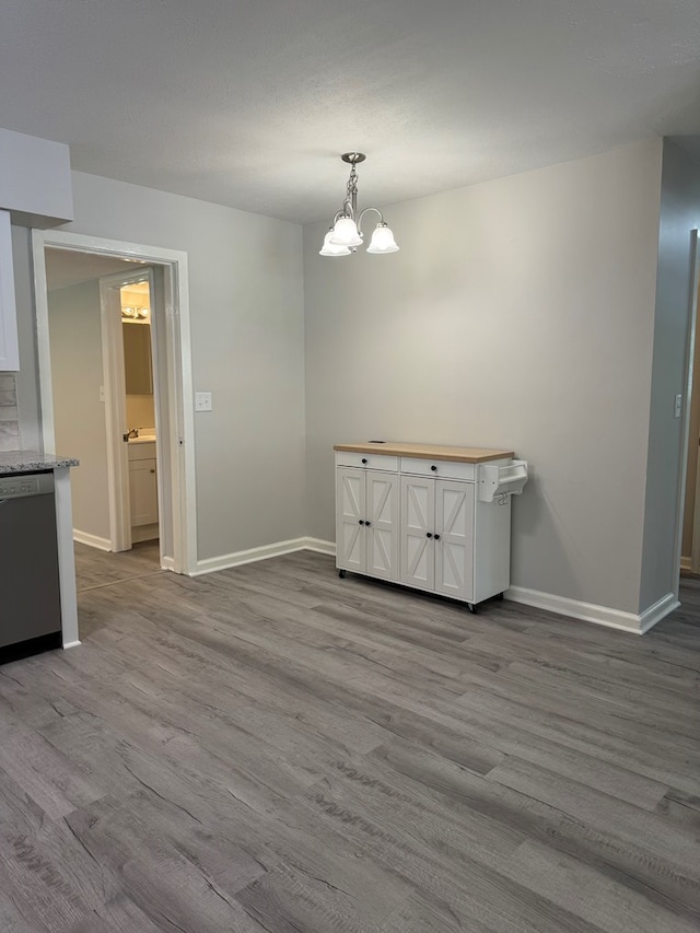 1508 Emerson Ave, Columbus, GA 31907 - unfurnished dining area featuring wood finished floors and a chandelier
