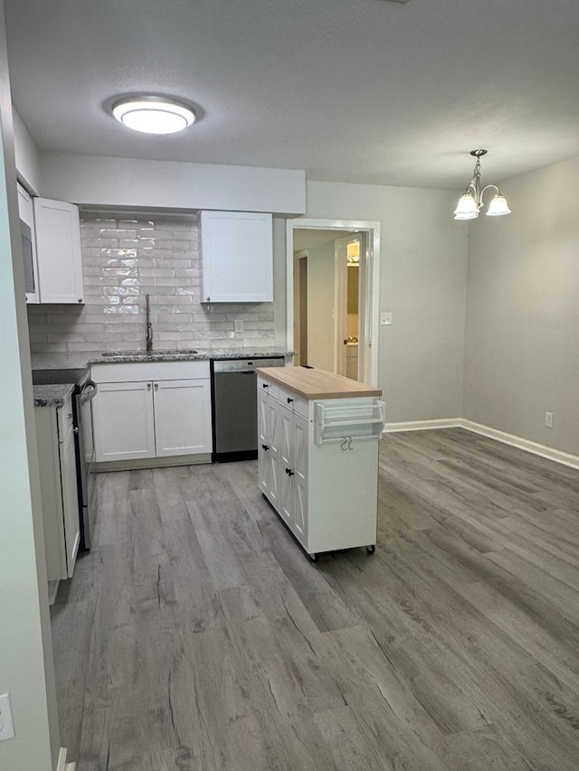 1508 Emerson Ave, Columbus, GA 31907 - kitchen with stainless steel appliances, light wood-style flooring, white cabinetry, backsplash, and a chandelier