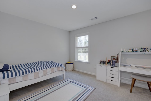 bedroom with light carpet, visible vents, and baseboards