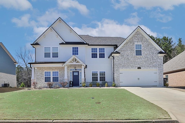 view of front of property with central air condition unit, concrete driveway, a front yard, stone siding, and an attached garage