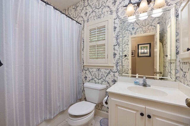 1018 Annbriar Ln, Columbus, GA 31909 - bathroom featuring wallpapered walls, toilet, vanity, tile patterned floors, and baseboards