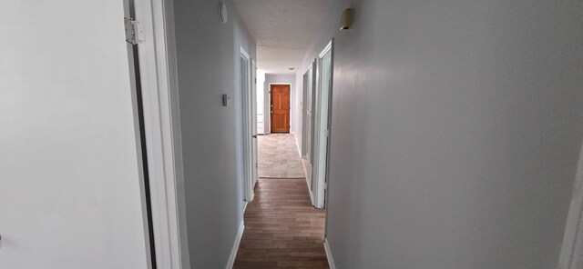1526 Barcelona Dr, Columbus, GA 31907 - hallway with baseboards and dark wood-style floors